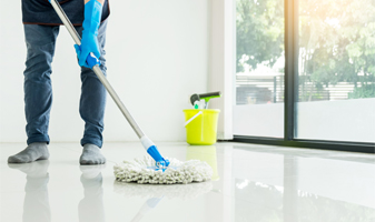 This image shows a man mopping a white epoxy floor.