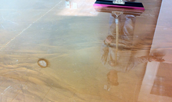 This image shows a metallic epoxy floor that is very shiny. The floors color is brown.