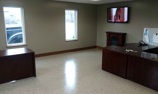 This image shows an office floor with a cream flake epoxy floor.