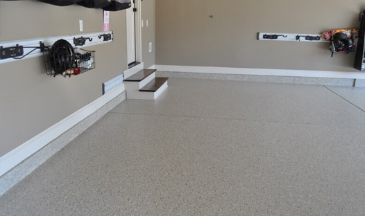 This image shows an garage with a cream flake epoxy floor.