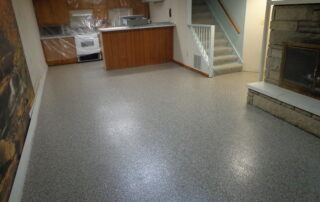 This image shows a basement with gray epoxy floor.
