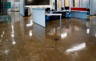 This image shows an office with a brown stained concrete floor.