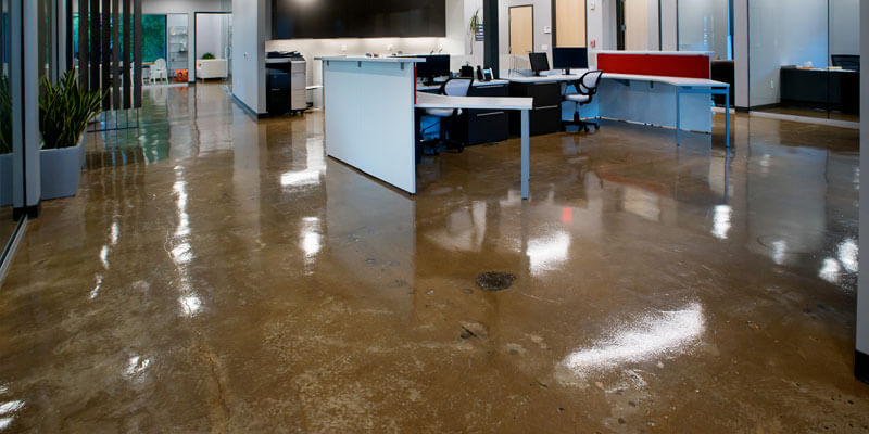This image shows an office with a brown stained concrete floor.