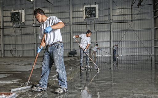 The image shows men painting a floor.
