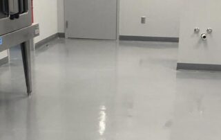 This image shows a commercial building floor with a gray epoxy floor.