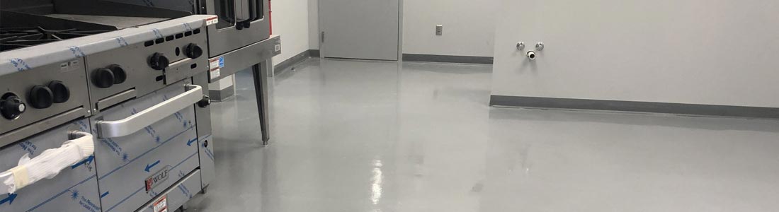 This image shows a commercial building floor with a gray epoxy floor.