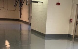 This image shows a commercial building floor with a gray epoxy floor.