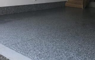 This image shows an garage with a flake epoxy floor.