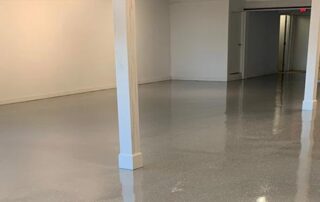 This image shows an commercial building floor with a gray epoxy floor.