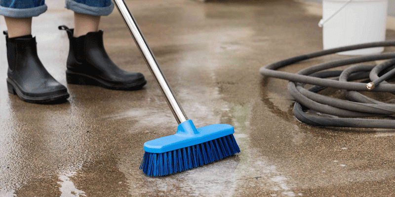 This image shows a man brushing the floor.