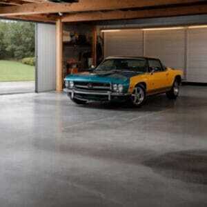 garage epoxy flooring This image shows a colorful car inside a garage that was newly polished.